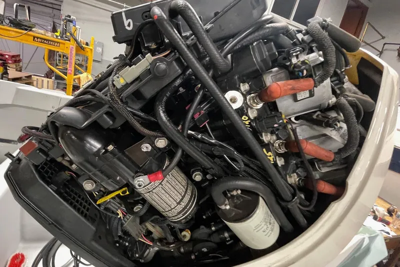 Slide: The Image of Close-up of a 1995 Boston Whaler Justice boat engine in a workshop setting. - 5