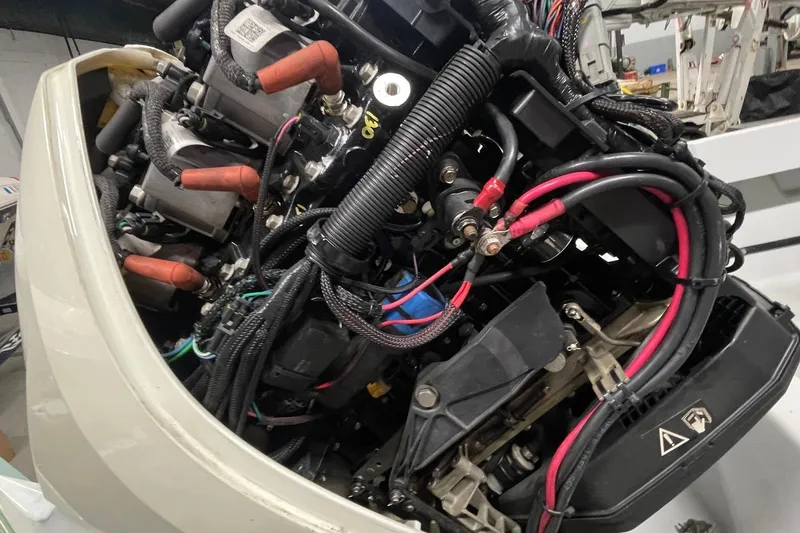 Slide: The Image of Close-up of a 1995 Boston Whaler Justice engine with visible wiring and components. - 6