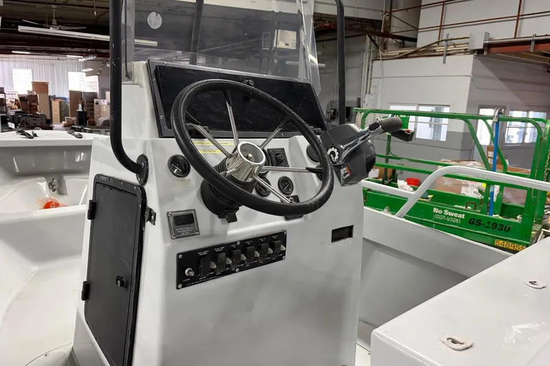 Slide: The Image of 1995 Boston Whaler Justice boat console with steering wheel and control panel. - 7