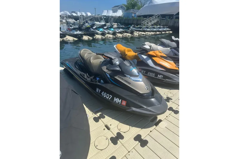 The Image of 2016 Sea-Doo GTX Limited 300 jet ski docked at marina with other watercraft. - 1