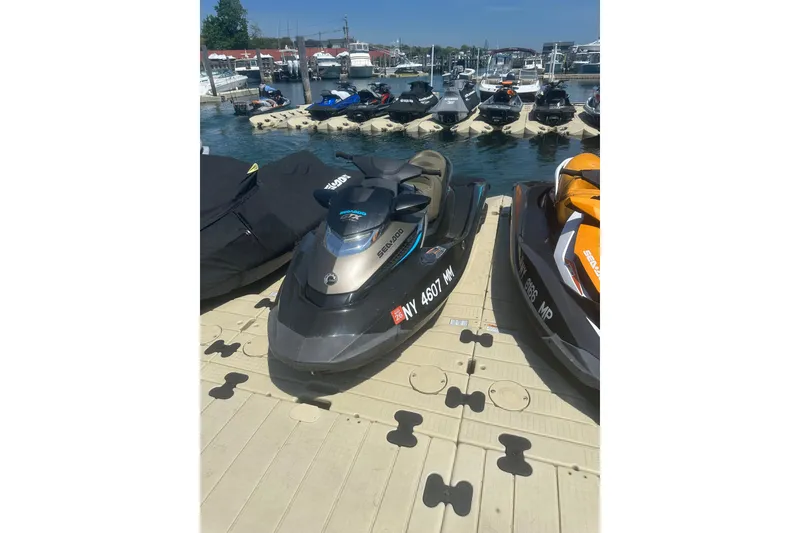 Slide: The Image of 2016 Sea-Doo GTX Limited 300 jet ski docked at a marina with other watercraft. - 3