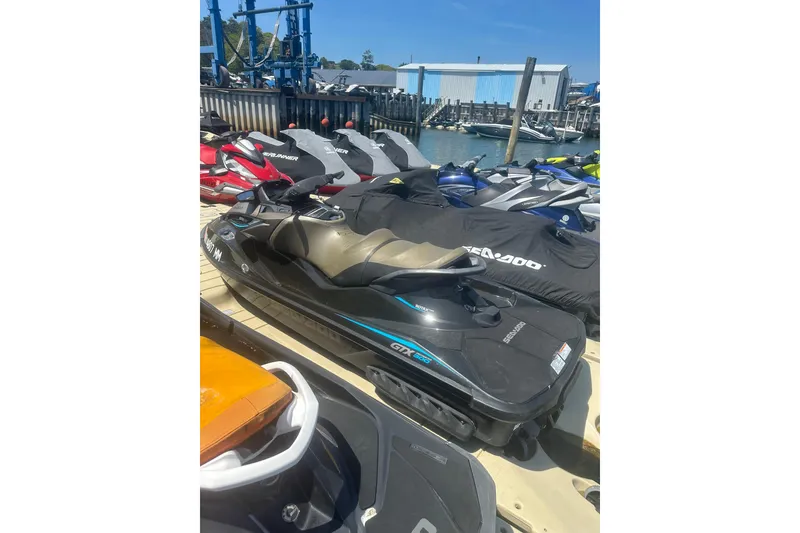 Slide: The Image of 2016 Sea-Doo GTX Limited 300 jet ski docked among other watercrafts. - 4