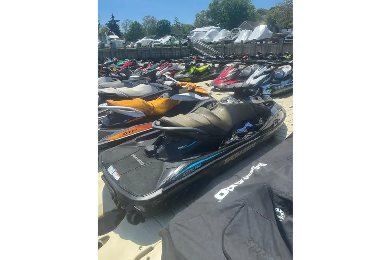 Slide: The Image of 2016 Sea-Doo GTX Limited 300 jet ski parked among others at a marina. - 5