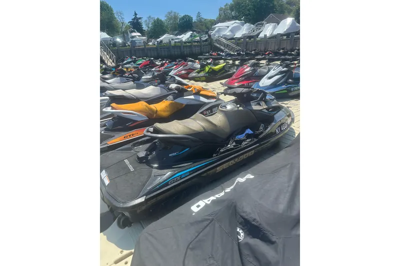 Slide: The Image of 2016 Sea-Doo GTX Limited 300 jet ski parked among others at a marina. - 6