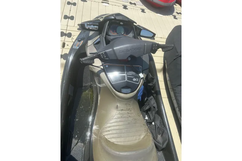 Slide: The Image of 2016 Sea-Doo GTX Limited 300 jet ski dashboard and seat on dock. - 8
