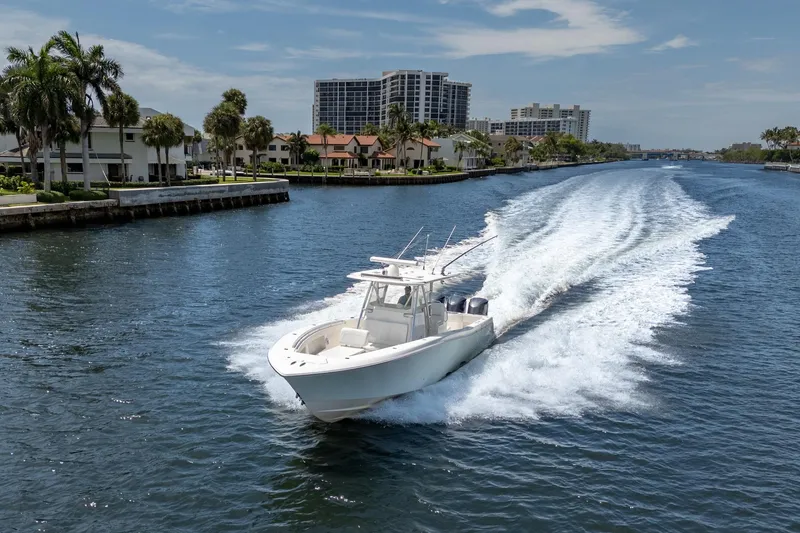 Slide: The Image of 2017 Invincible 39 Open Fisherman cruising on a scenic waterway with waterfront homes. - 12