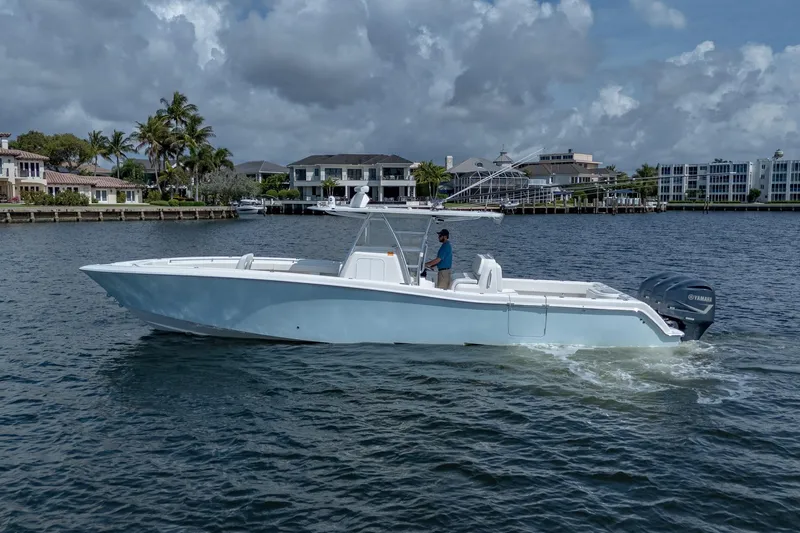 Slide: The Image of 2017 Invincible 39 Open Fisherman boat cruising on a scenic waterfront. - 13