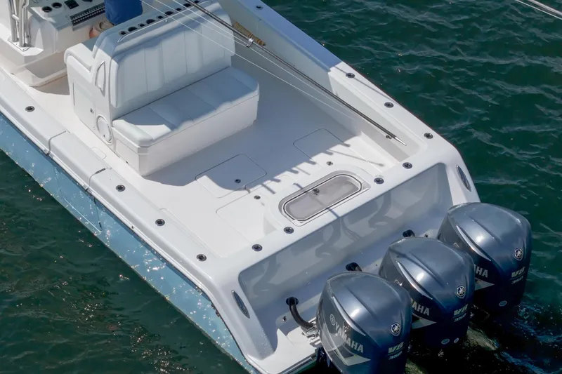 Slide: The Image of 2017 Invincible 39 Open Fisherman boat with triple Yamaha V8 engines on water. - 16