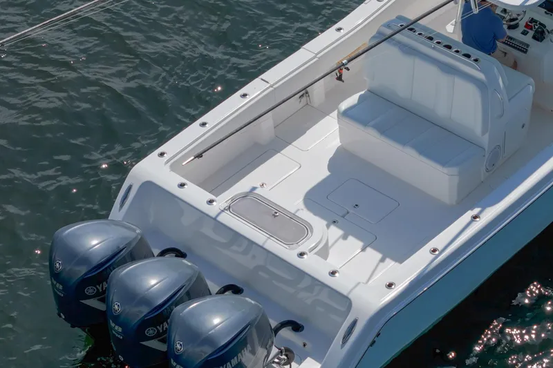 Slide: The Image of 2017 Invincible 39 Open Fisherman boat with triple Yamaha outboard engines on water. - 17