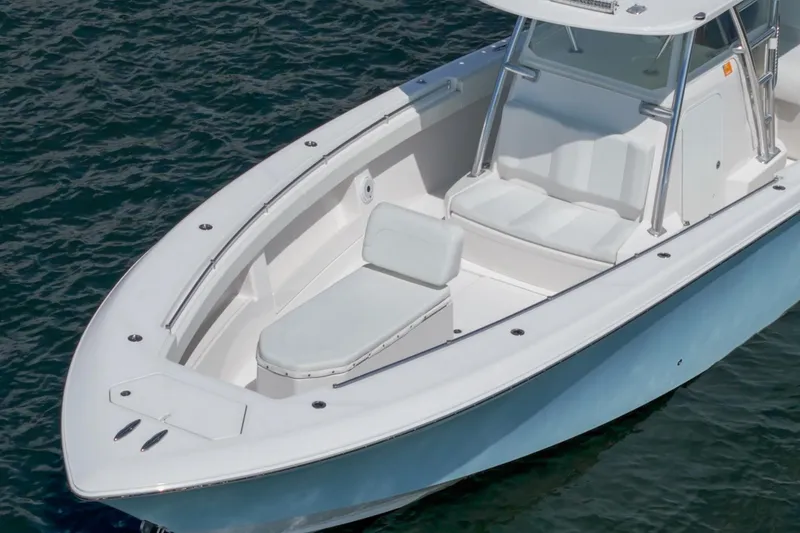 Slide: The Image of 2017 Invincible 39 Open Fisherman boat on water, featuring spacious seating and sleek design. - 21