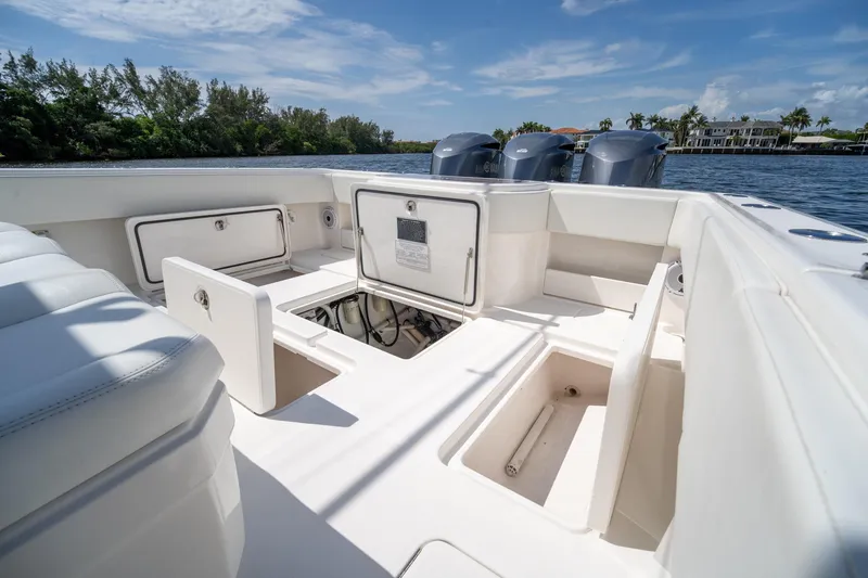 Slide: The Image of 2017 Invincible 39 Open Fisherman boat interior with storage compartments and engines. - 25