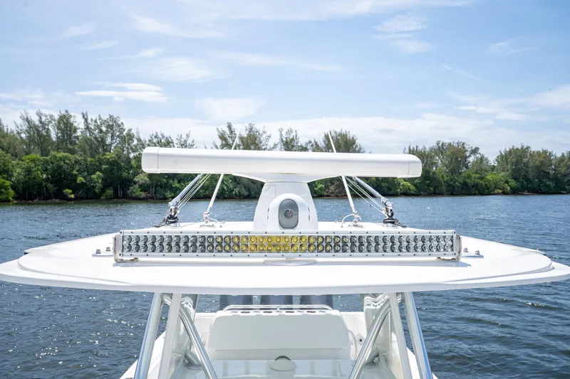 Slide: The Image of 2017 Invincible 39 Open Fisherman boat with radar and light bar on calm water. - 33