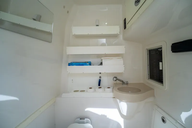 Slide: The Image of Compact bathroom in 2017 Invincible 39 Open Fisherman boat with sink and storage shelves. - 35
