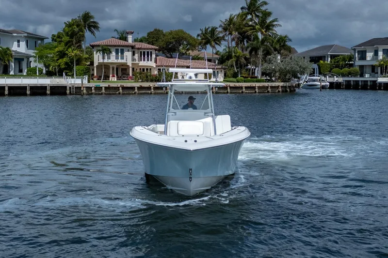 Slide: The Image of 2017 Invincible 39 Open Fisherman boat cruising near waterfront homes. - 9