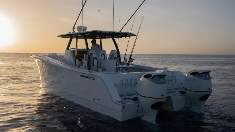 The Image of 2025 Hammer Yachts HammerCat 35 cruising at sunset on calm ocean waters. - 1