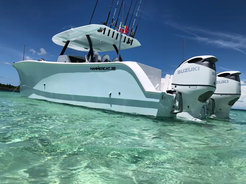 Slide: The Image of 2025 Hammer Yachts HammerCat 35 in clear turquoise water, featuring dual Suzuki engines. - 17