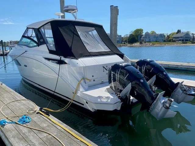 Slide: The Image of 2022 Sea Ray Sundancer 320 docked with dual outboard engines. - 1