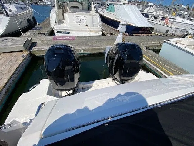 Slide: The Image of 2022 Sea Ray Sundancer 320 with twin outboard engines at the marina. - 9