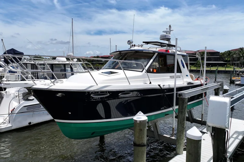 Slide: The Image of 2012 Cutwater C-26 boat docked at marina under clear blue sky. - 1
