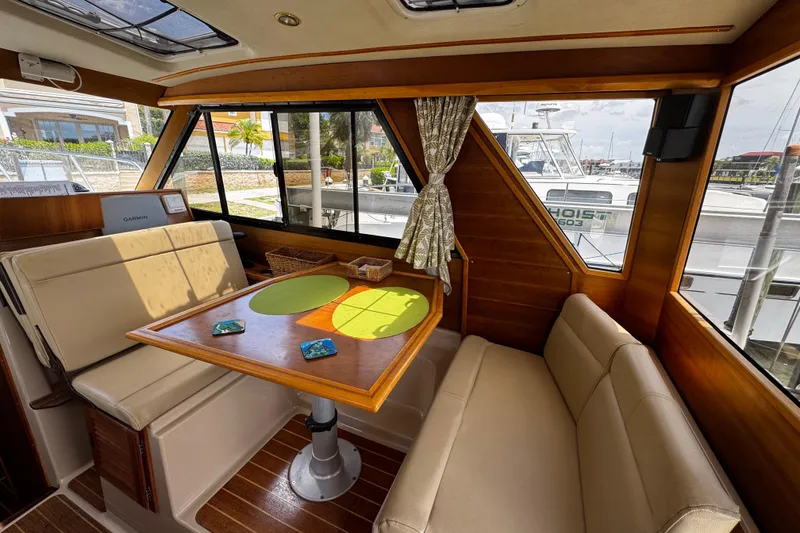 Slide: The Image of Interior of 2012 Cutwater C-26 boat with cozy seating and dining area. - 11