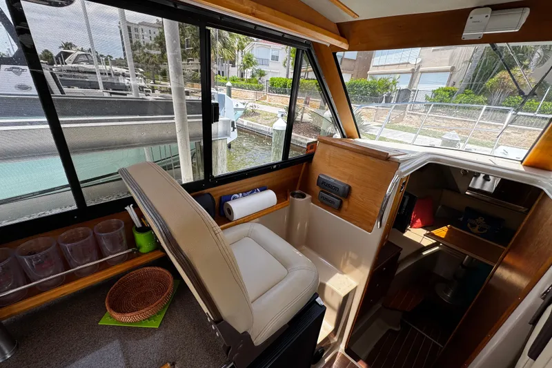Slide: The Image of Interior of a 2012 Cutwater C-26 boat with helm and seating area. - 13