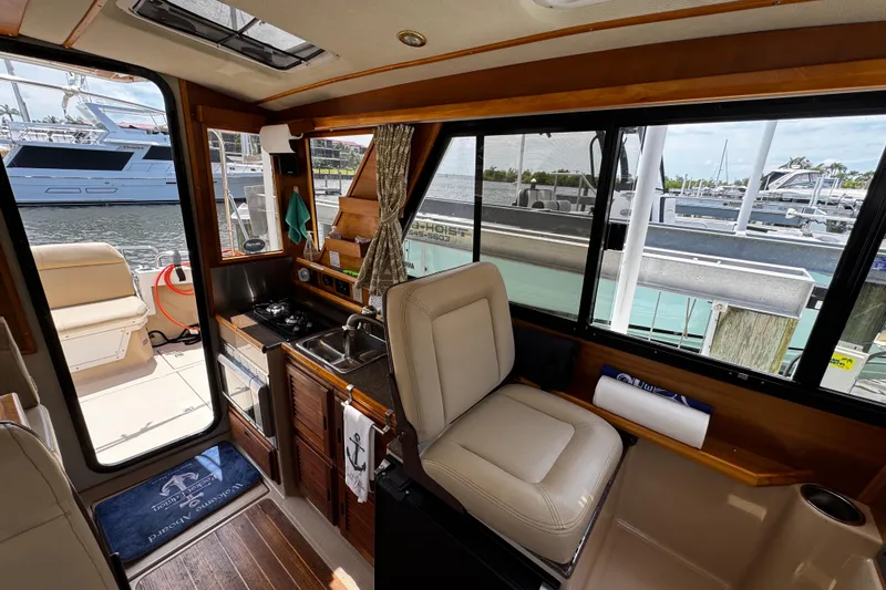 Slide: The Image of Interior of 2012 Cutwater C-26 boat with kitchenette and seating, docked at marina. - 16