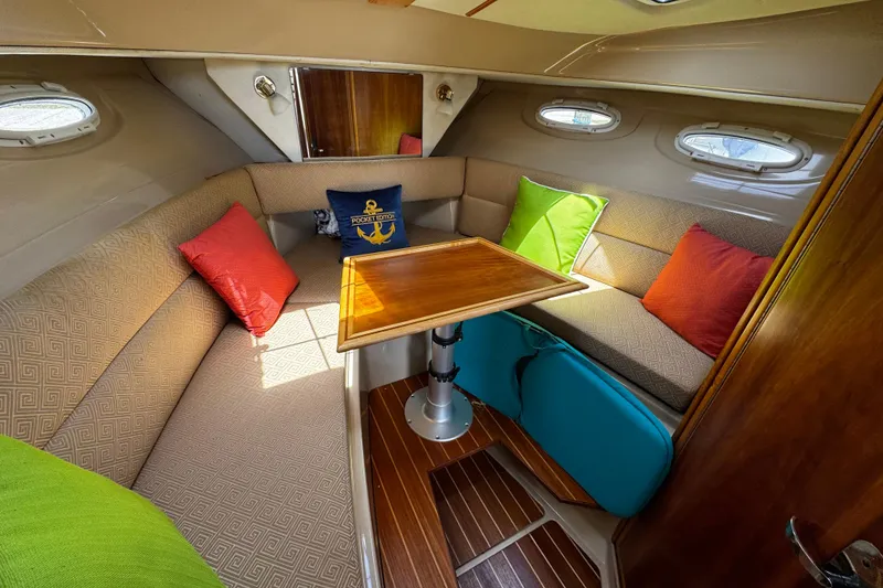 Slide: The Image of Cozy interior of 2012 Cutwater C-26 boat with colorful cushions and wooden table. - 18