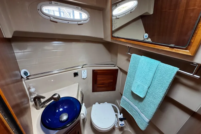 Slide: The Image of Bathroom interior of 2012 Cutwater C-26 boat with blue sink and towel. - 20