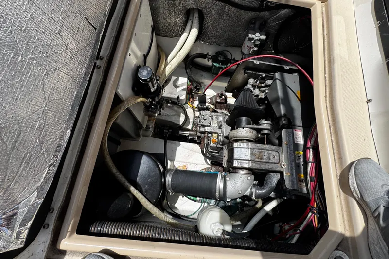 Slide: The Image of Engine compartment of a 2012 Cutwater C-26 boat, showcasing mechanical components and wiring. - 21