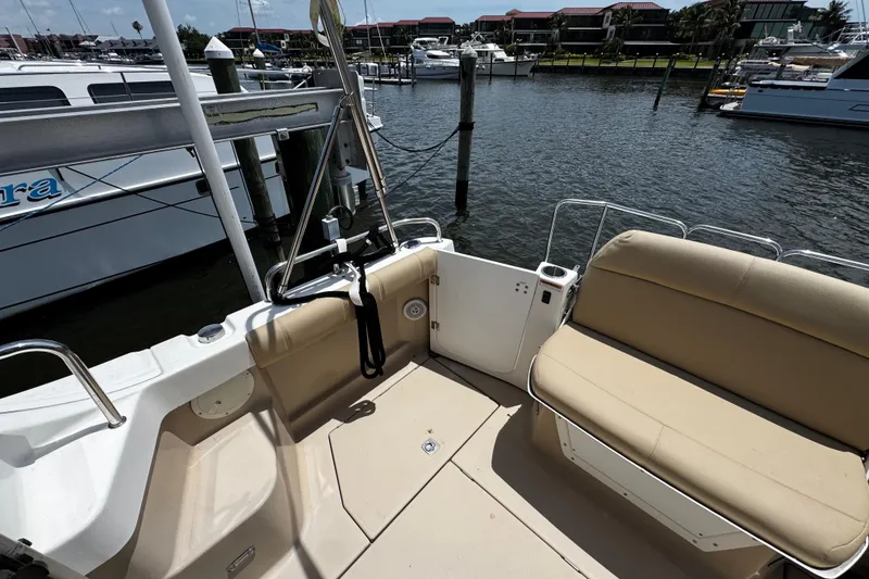 Slide: The Image of 2012 Cutwater C-26 boat interior with beige seating at marina dock. - 7
