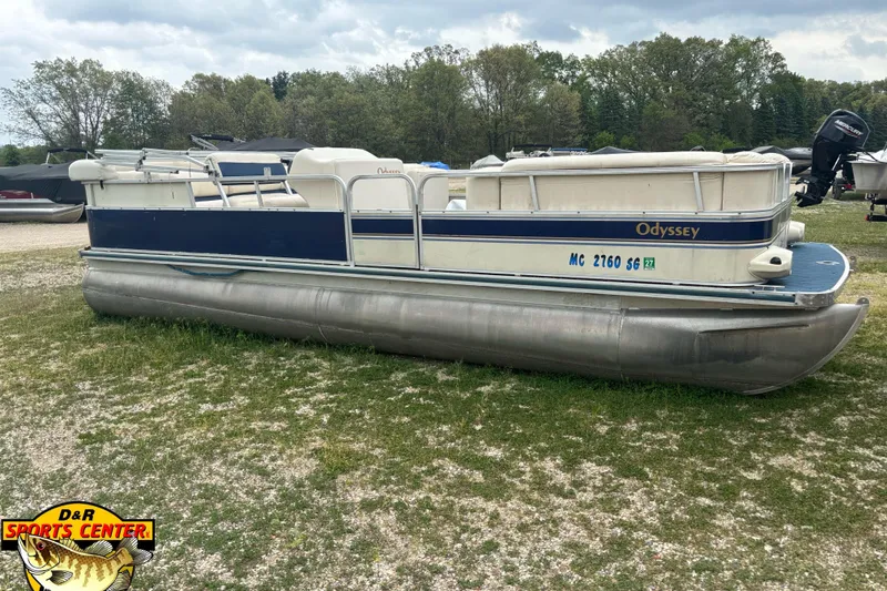 Slide: The Image of 2002 Odyssey Pontoons 2303L pontoon boat on grassy area, overcast sky. - 3
