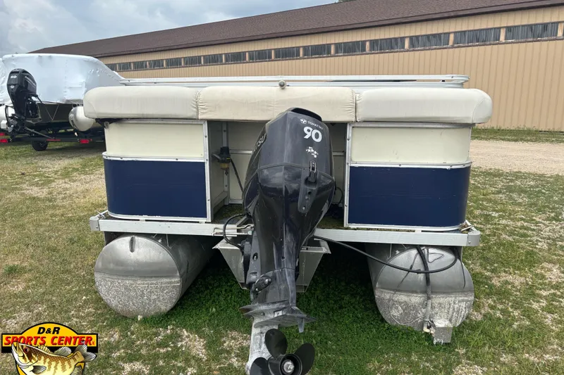 Slide: The Image of 2002 Odyssey Pontoons 2303L with Tohatsu 90 outboard motor, parked on grass. - 6