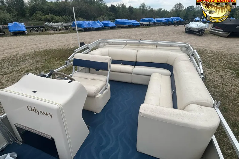 Slide: The Image of 2002 Odyssey Pontoons 2303L with spacious seating, parked outdoors. - 7