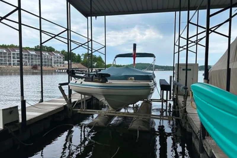 The Image of 2006 Hurricane FunDeck GS 232 OB boat docked under a covered marina. - 0