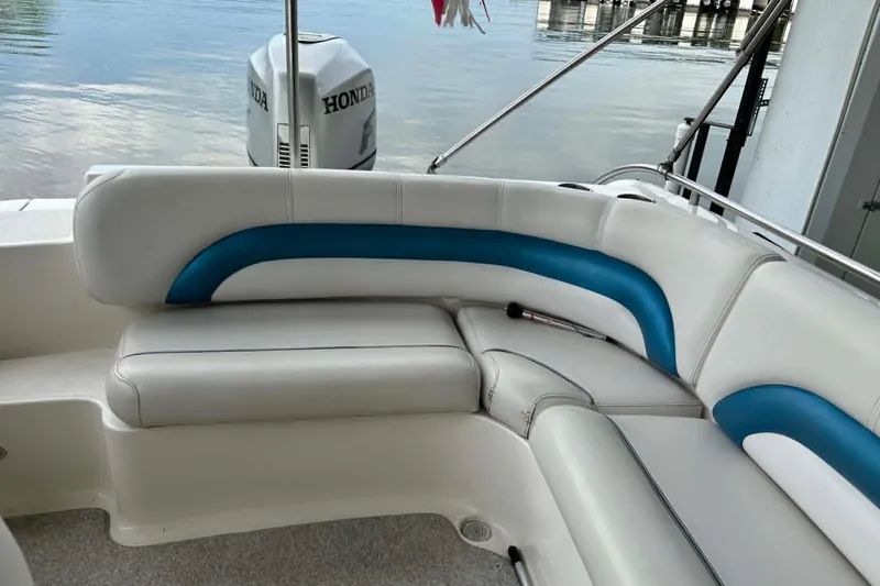 Slide: The Image of 2006 Hurricane FunDeck GS 232 OB boat interior with white and blue seating, Honda outboard motor. - 10
