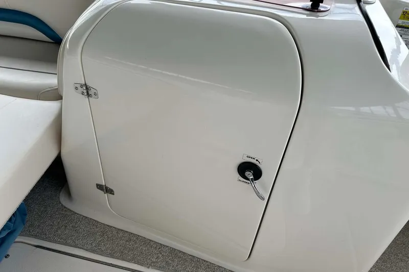 Slide: The Image of 2006 Hurricane FunDeck GS 232 OB boat storage compartment with handle and latch. - 16