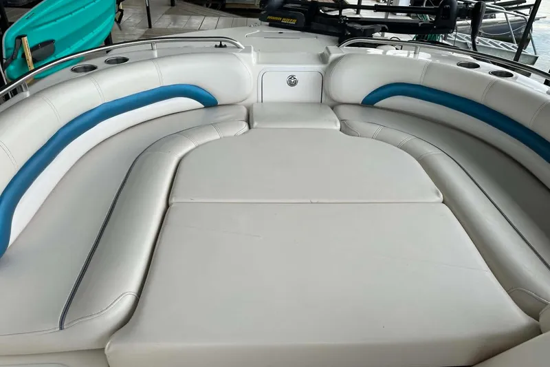 Slide: The Image of 2006 Hurricane FunDeck GS 232 OB boat interior with white and blue cushioned seating. - 2
