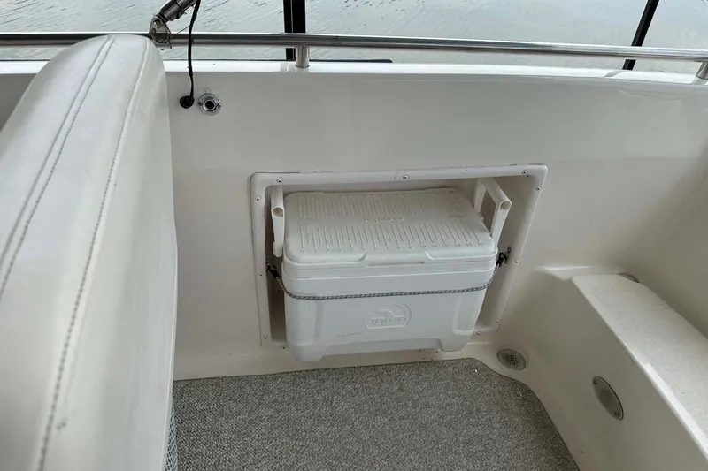 Slide: The Image of 2006 Hurricane FunDeck GS 232 OB boat interior with built-in cooler storage. - 21