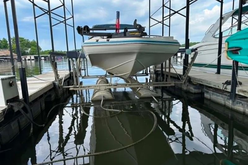 Slide: The Image of 2006 Hurricane FunDeck GS 232 OB boat docked on a lift at a marina. - 23