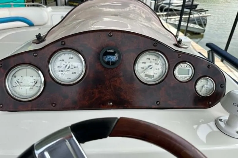 Slide: The Image of Dashboard of 2006 Hurricane FunDeck GS 232 OB boat with gauges and steering wheel. - 4