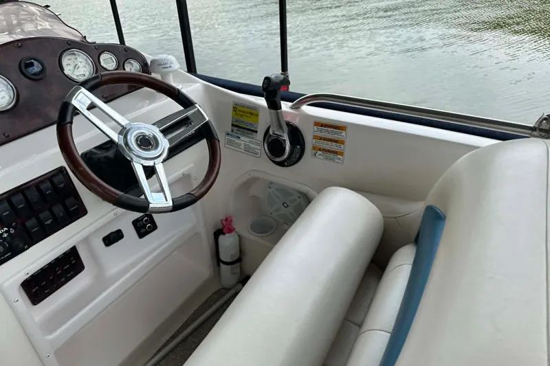 Slide: The Image of 2006 Hurricane FunDeck GS 232 OB boat cockpit with steering wheel and controls. - 5