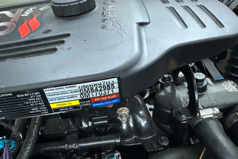 Slide: The Image of Engine of 2006 Hurricane FunDeck GS 232 OB with visible serial numbers and labels. - 7