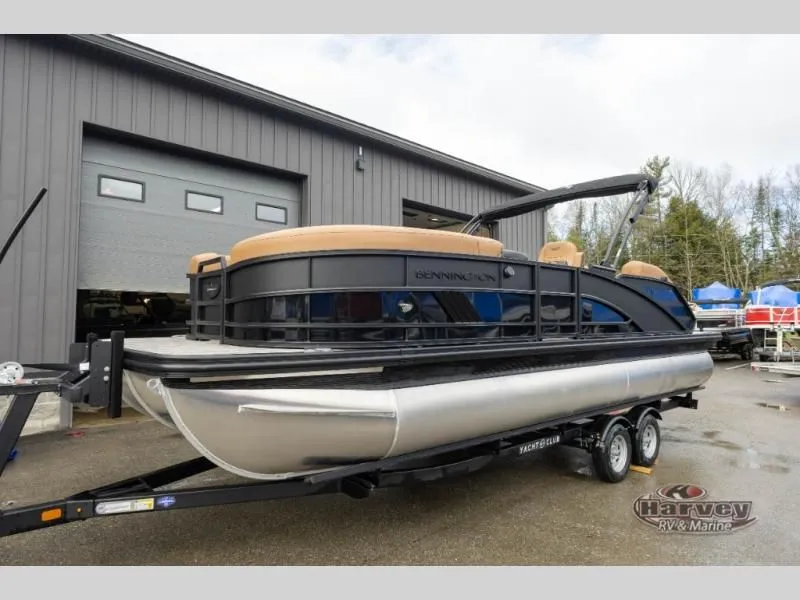 The Image of 2026 M Series 23 MSB pontoon boat on trailer outside garage. - 1