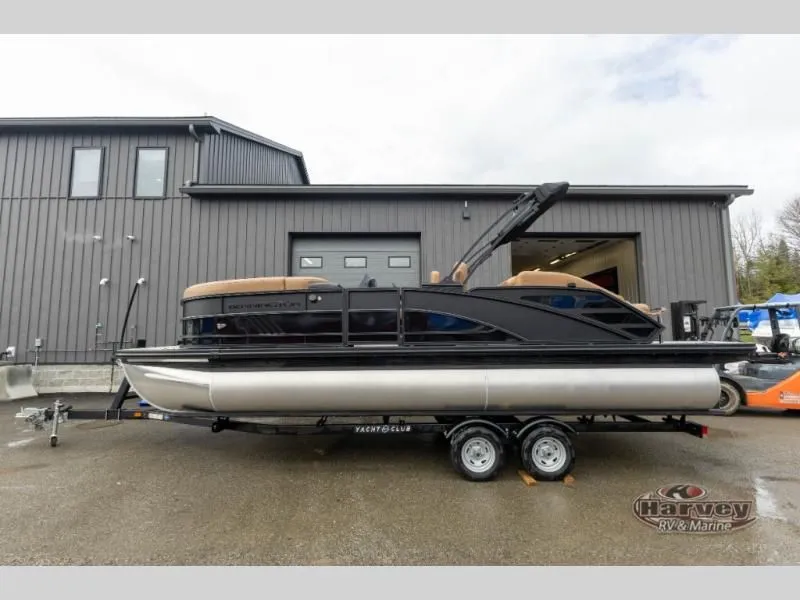 Slide: The Image of 2026 M Series 23 MSB pontoon boat on trailer in front of gray building. - 4