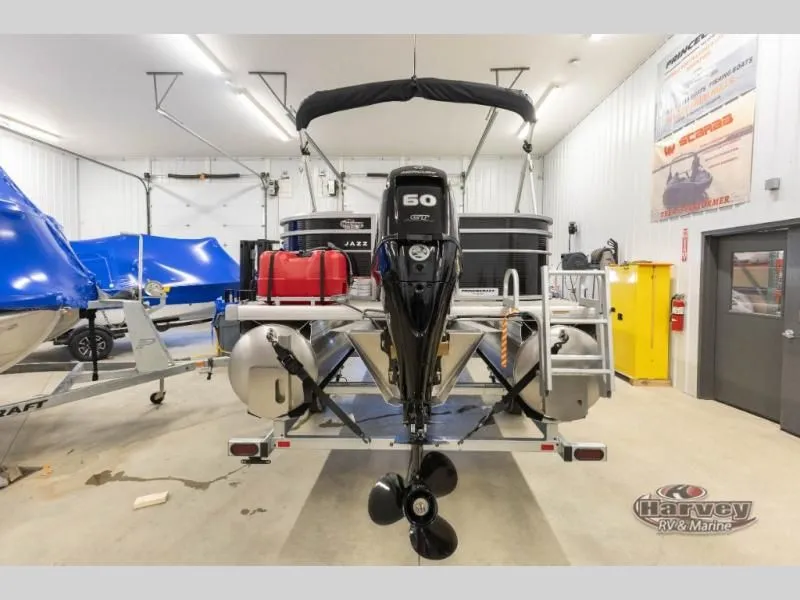 Slide: The Image of 2026 Jazz 21-2S pontoon boat in showroom with outboard motor. - 6