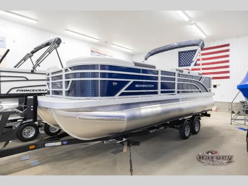 Slide: The Image of 2026 Bennington pontoon boat in showroom with American flag. - 3