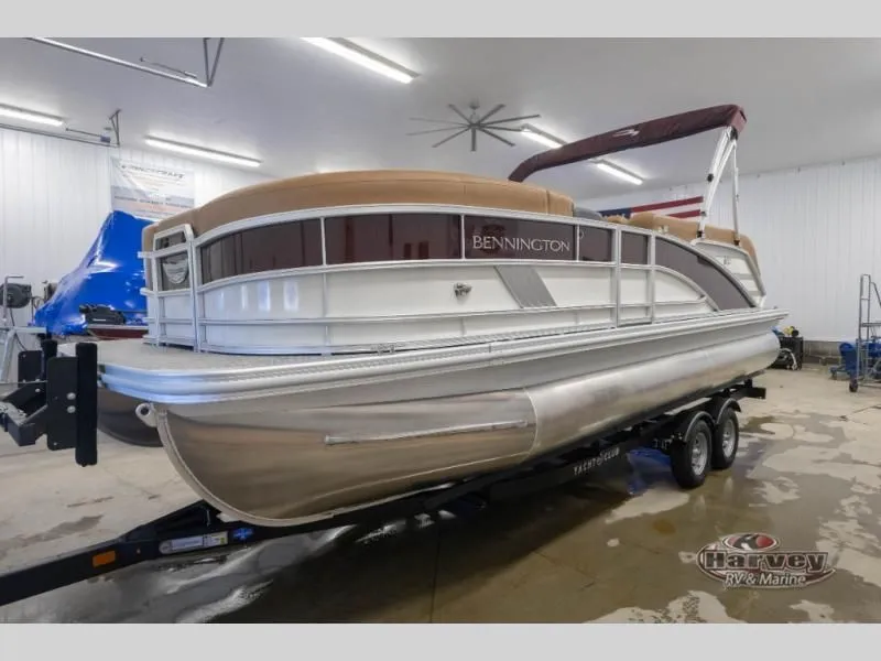 Slide: The Image of 2026 Bennington pontoon boat in a workshop on a trailer. - 6