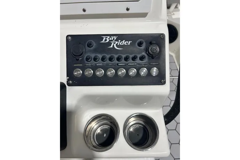 Slide: The Image of 2020 KenCraft 239 Bay Rider control panel with switches and cup holders. - 11