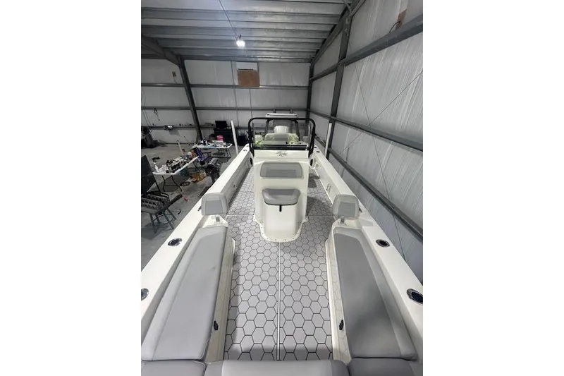 Slide: The Image of 2020 KenCraft 239 Bay Rider boat interior with hexagonal flooring in a spacious garage. - 17