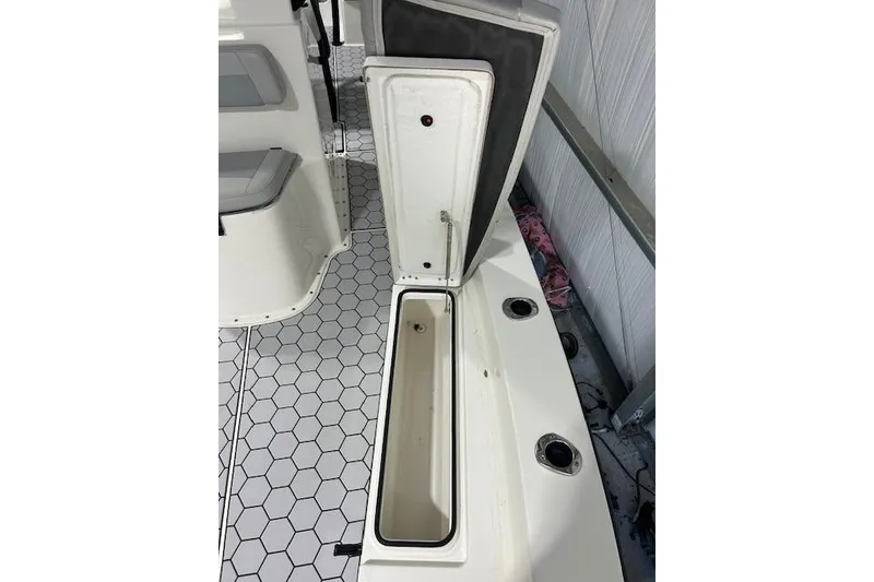 Slide: The Image of 2020 KenCraft 239 Bay Rider boat with open storage compartment and hexagonal floor pattern. - 18
